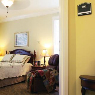 A cozy hotel bedroom with elegant decor and soft lighting.