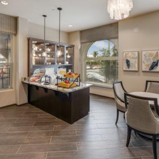 A modern kitchen and dining area with a central island, contemporary lighting, and elegant decor.