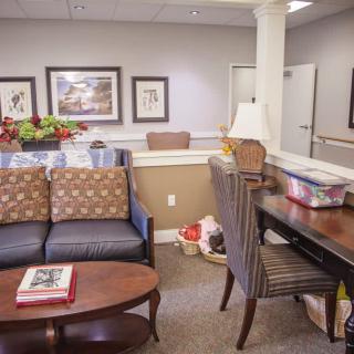 A cozy waiting room with comfortable seating and decorated walls.