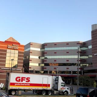 A GFS delivery truck parked in front of a commercial building.