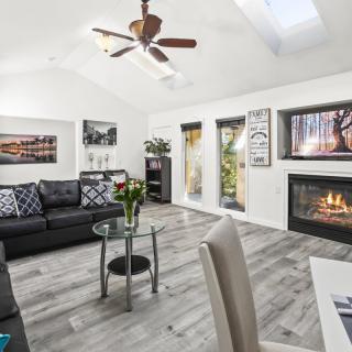 A modern living room with a cozy fireplace, stylish artwork, and comfortable seating.