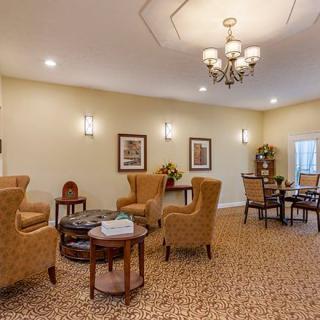A cozy living room with elegant seating and a chandelier.