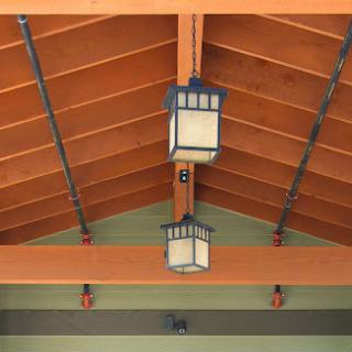 Ceiling view featuring decorative lanterns and wooden beams.