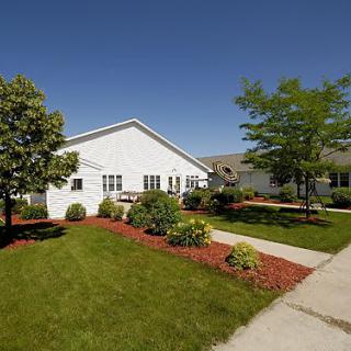 A suburban house with a well-maintained lawn and garden.