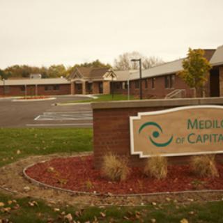 Exterior view of a healthcare facility with a welcoming sign.