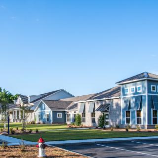 A view of a suburban neighborhood with modern houses and a clear blue sky.