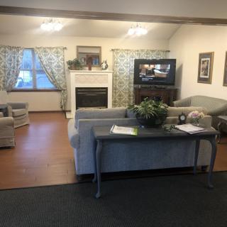 Cozy living room with a fireplace, sofa, and TV.