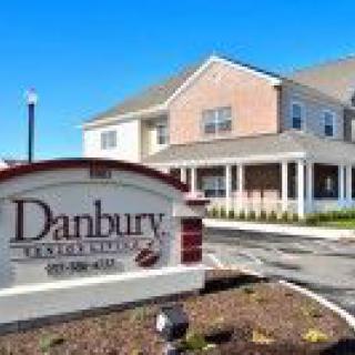 A building with a Danbury Senior Living sign in front of it.
