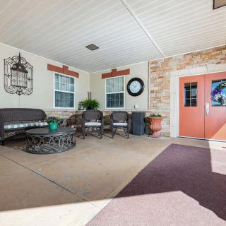 A cozy outdoor patio with comfortable seating and decorative elements.