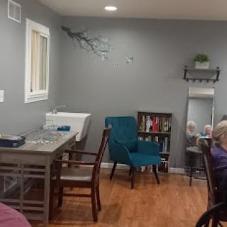 A cozy and modern interior featuring a comfortable seating area with a table and bookshelf.