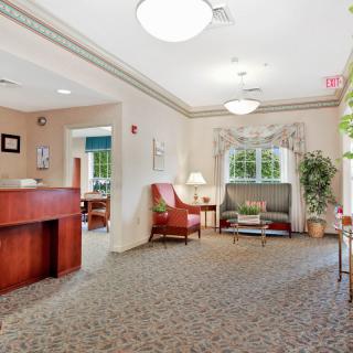 A welcoming lobby with a reception desk, seating area, and decorative elements.