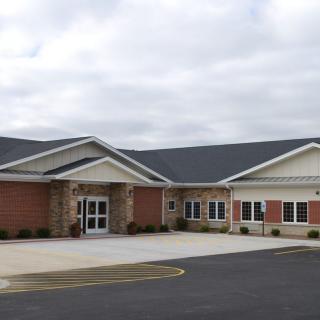 A single-story brick building with a gabled roof, likely a school or educational facility.