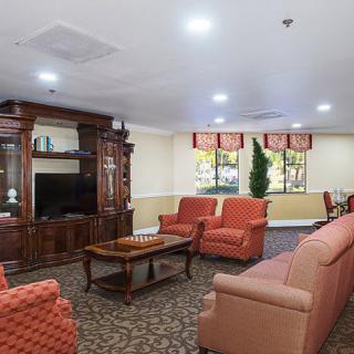 A cozy living room with sofas and a wooden entertainment center.