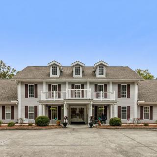 A large colonial-style mansion with a symmetrical facade and multiple windows.