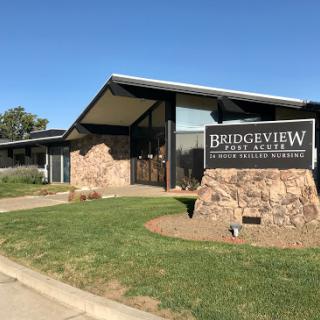 A modern building featuring a stone exterior and a prominent sign for Bridgesview.
