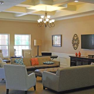A cozy living room with comfortable seating and elegant lighting.