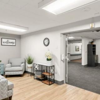 A modern office waiting area with comfortable seating and stylish decor.