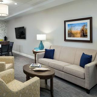 A modern living room with a comfortable sofa, armchairs, and stylish decor.