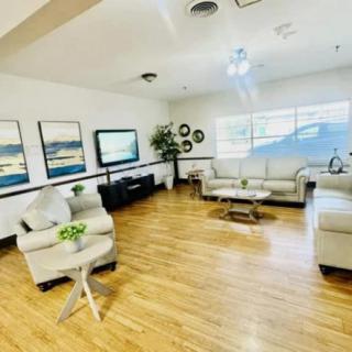 A modern living room with stylish furniture, including sofas and a coffee table, set on a hardwood floor.
