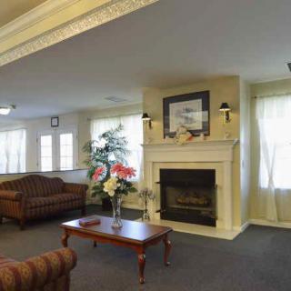 A cozy living room with a fireplace and comfortable seating.