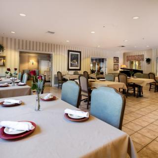 A well-decorated restaurant dining room with neatly arranged tables and chairs.