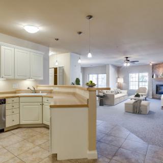 A spacious and inviting open-concept kitchen and living room, featuring modern appliances and neutral decor.