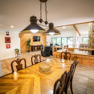 A cozy open-concept dining and living area featuring wooden furniture and a warm atmosphere.