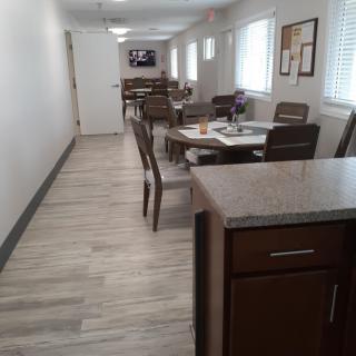 A modern dining area with neatly arranged tables and chairs.