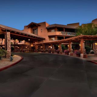 Luxurious desert hotel entrance at night.