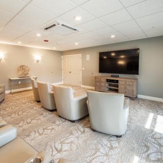 A modern living room with comfortable seating and a large television.