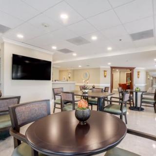 Spacious hotel lobby with modern seating and a TV for guest comfort.