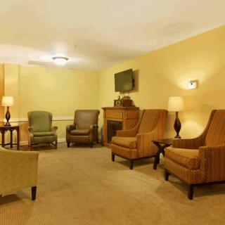 A cozy living room with multiple seating options, a television, and a fireplace.