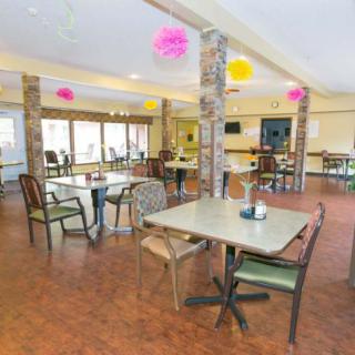 A spacious indoor dining area with tables, chairs, and colorful decorations.