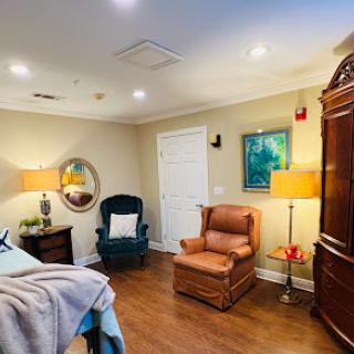 A cozy bedroom setup featuring a mix of classic and contemporary furniture.