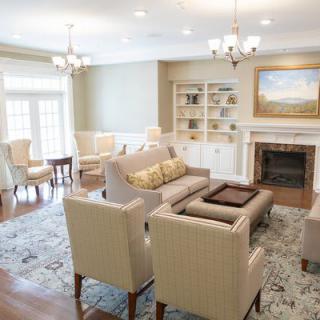A cozy living room featuring elegant seating, a fireplace, and stylish decor.
