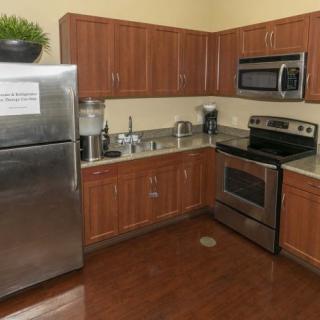A modern kitchen featuring stainless steel appliances and wooden cabinets.