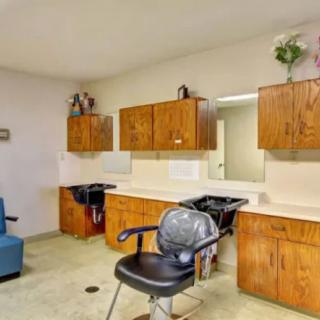 A well-organized hair salon interior with chairs and cabinets.