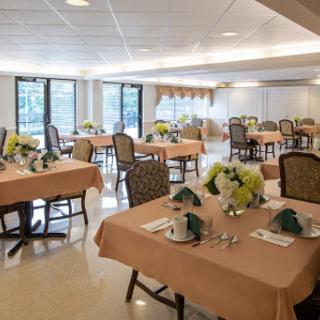 A beautifully arranged dining area with elegant tables set for a special occasion.