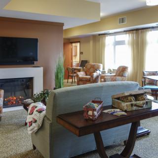 A cozy living room with a fireplace, television, and comfortable seating.