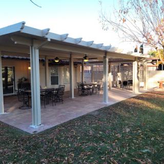 A spacious outdoor patio featuring a pergola and seating, perfect for gatherings.