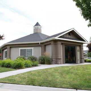 A charming residential house with a well-maintained lawn and landscaped garden.