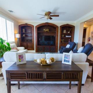Spacious living room with comfortable seating, decorative bookshelves, and elegant decor.