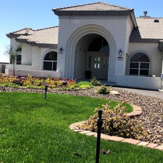 A modern house with a well-maintained lawn and garden.