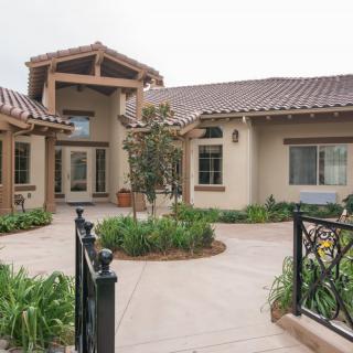 A modern residential house featuring a landscaped garden and elegant architectural design.