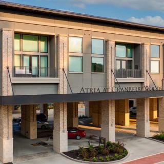 Modern exterior of a multi-story hotel building with large windows.