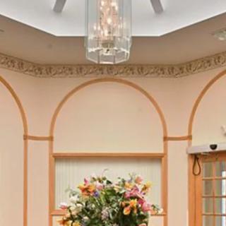 Elegant room interior with a central floral arrangement and a chandelier.
