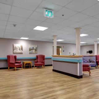 A spacious waiting area with comfortable seating and a reception desk.