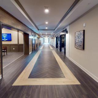 A modern, well-lit hallway with stylish flooring and contemporary decor.