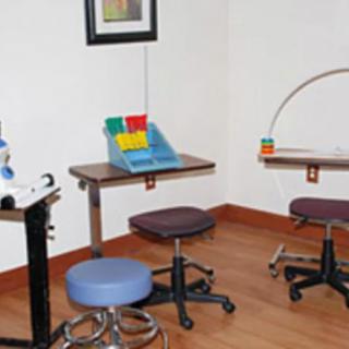 A pediatric therapy room equipped with tools for occupational therapy activities.