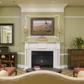 A cozy living room with a central fireplace, adorned with elegant decor.